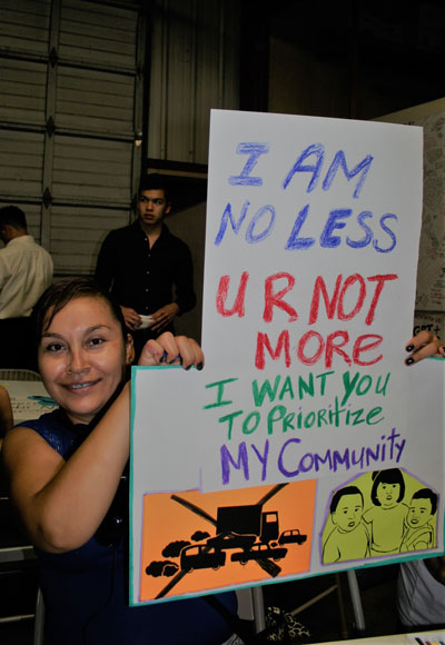 Llesenia Cevallos at the Transportation Justice Poster Making Workshop, 2015 Climate justice sign